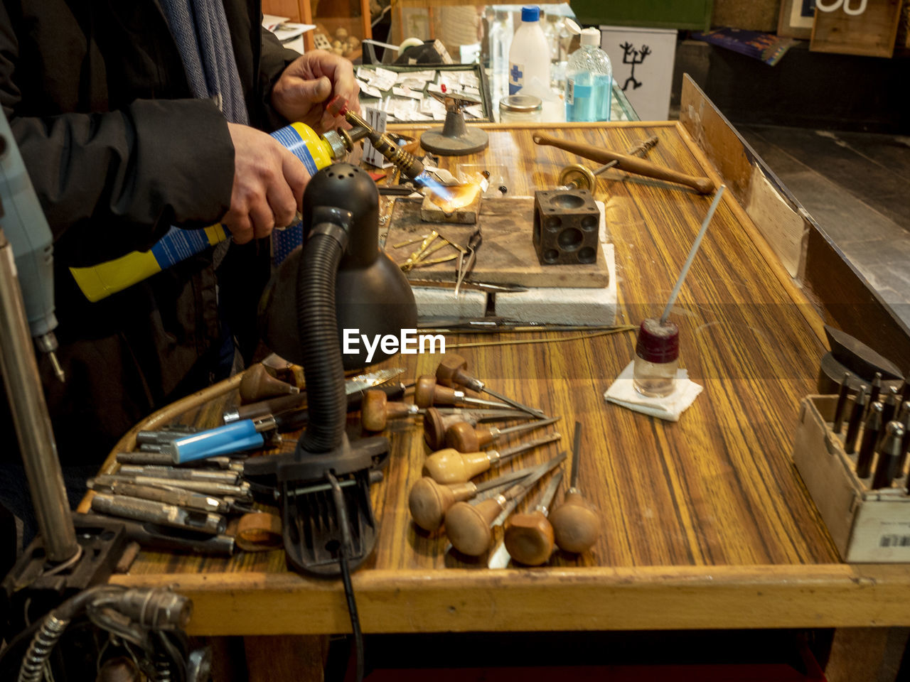 Midsection of man working at workshop