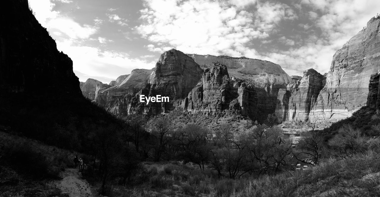 Panoramic view of mountain range against cloudy sky