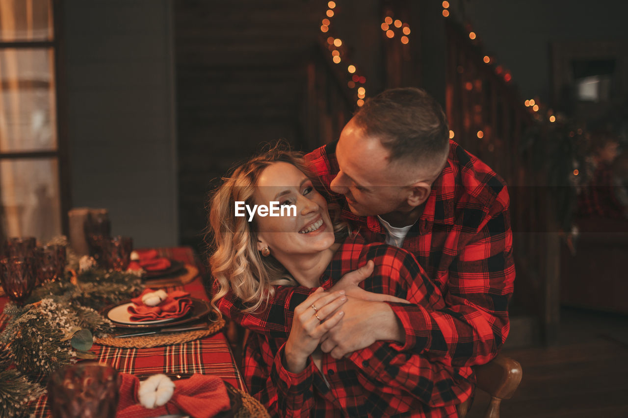 Candid authentic happy married couple spends time alone at lodge xmas decorated