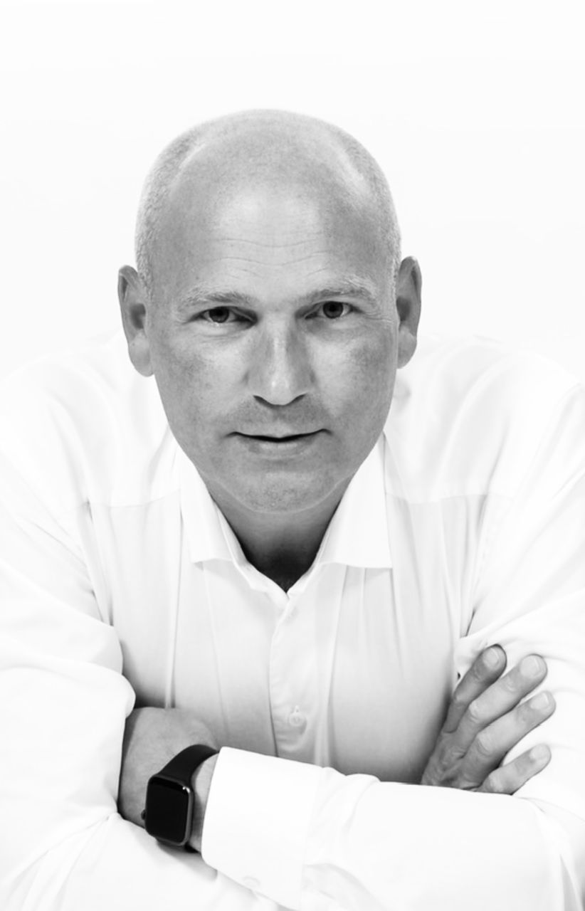 adult, portrait, one person, men, person, black and white, looking at camera, shaved head, indoors, front view, arms crossed, sitting, monochrome photography, monochrome, relaxation, mature adult, lifestyles, human face, button down shirt, emotion, waist up, headshot, completely bald