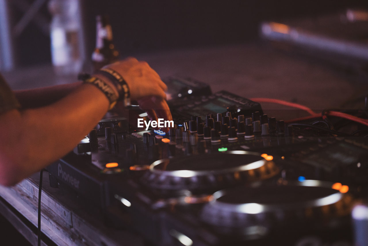 Cropped of hand playing turntable at concert