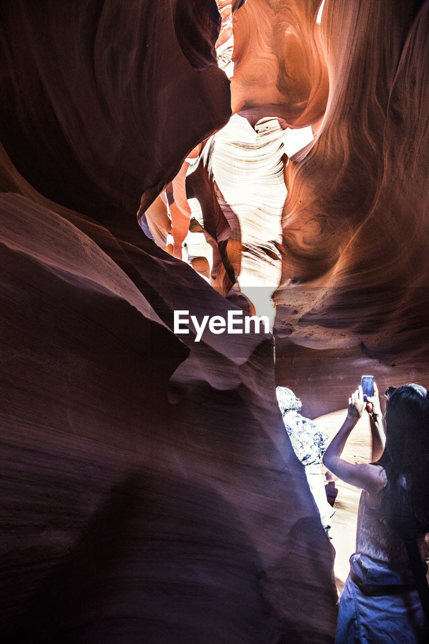 Woman photographing at antelope canyon