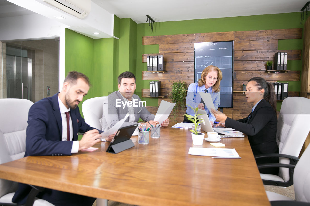 business colleagues working at desk in creative office