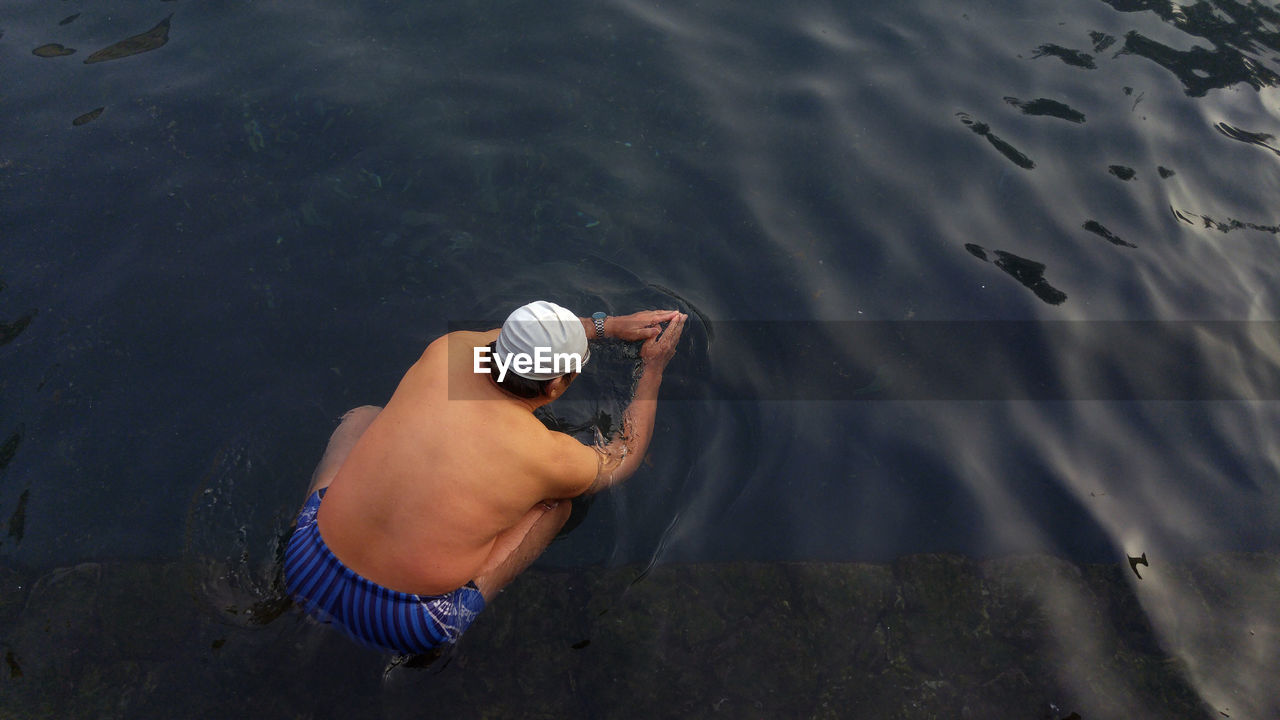 High angle view of man swimming in lake