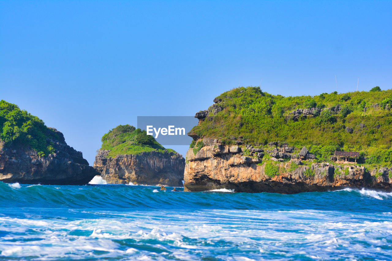 Scenic view of sea against clear blue sky