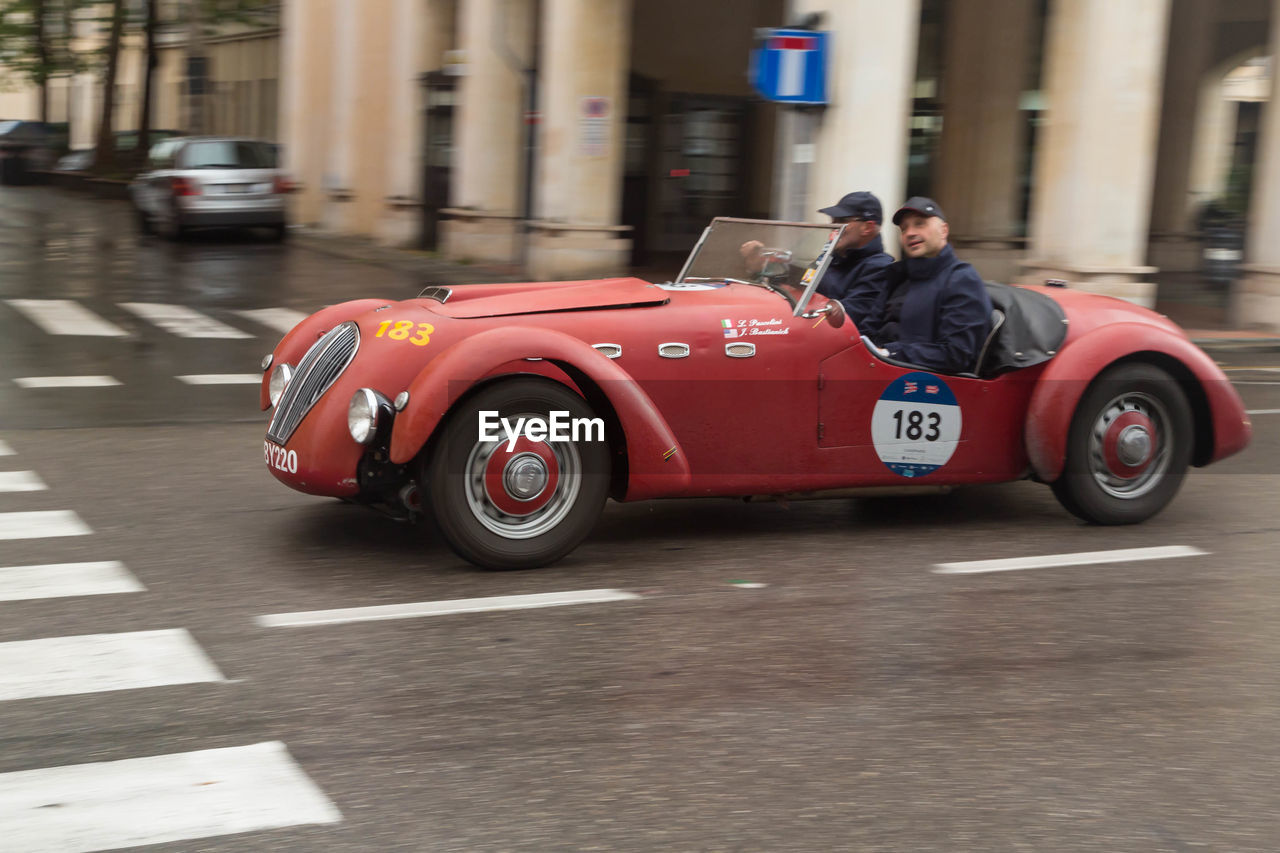 MAN AND CAR ON STREET