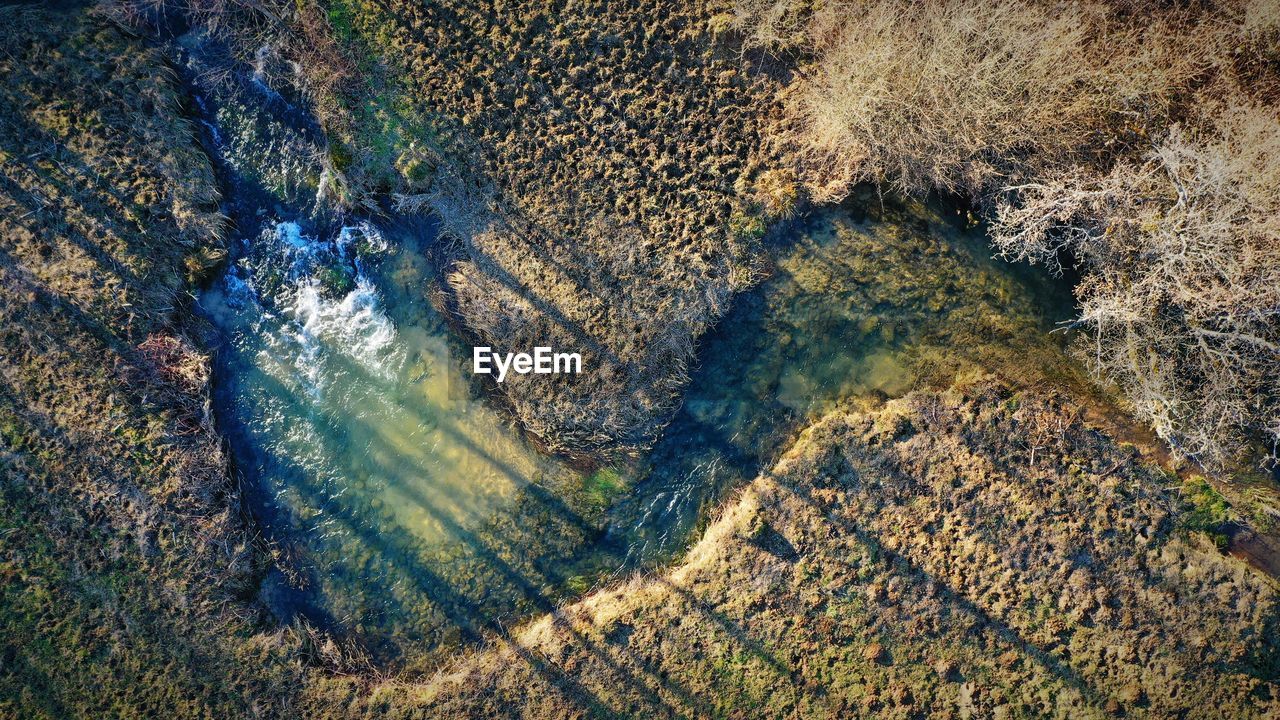 HIGH ANGLE VIEW OF SUNLIGHT FALLING ON ROCKS