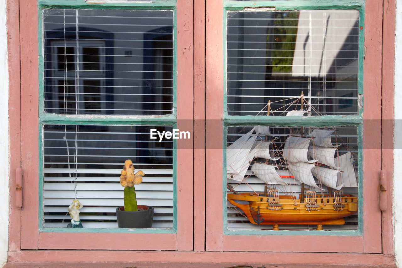 Miniature model of sailing ship seen through window of store