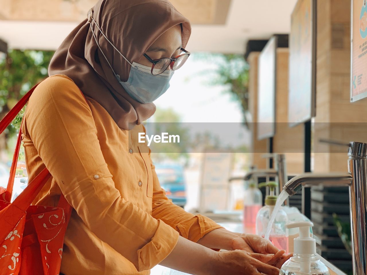 A girl washing her hands befor entering mall