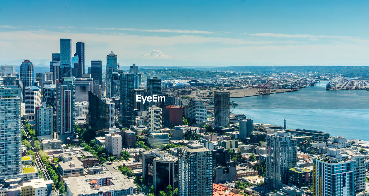 Buildings in downtown seattle with mount rainier in the distance.