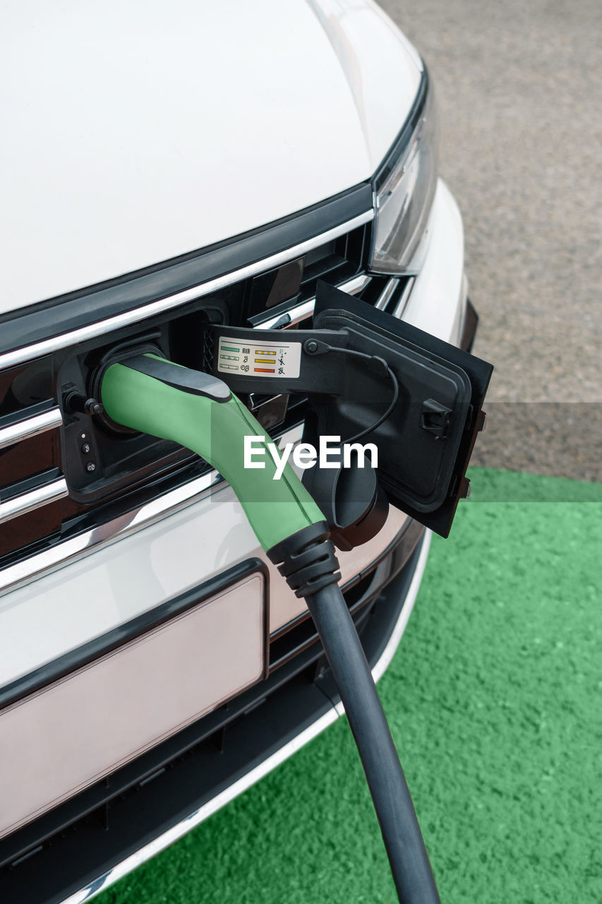 Detail of socket plugged into electric car