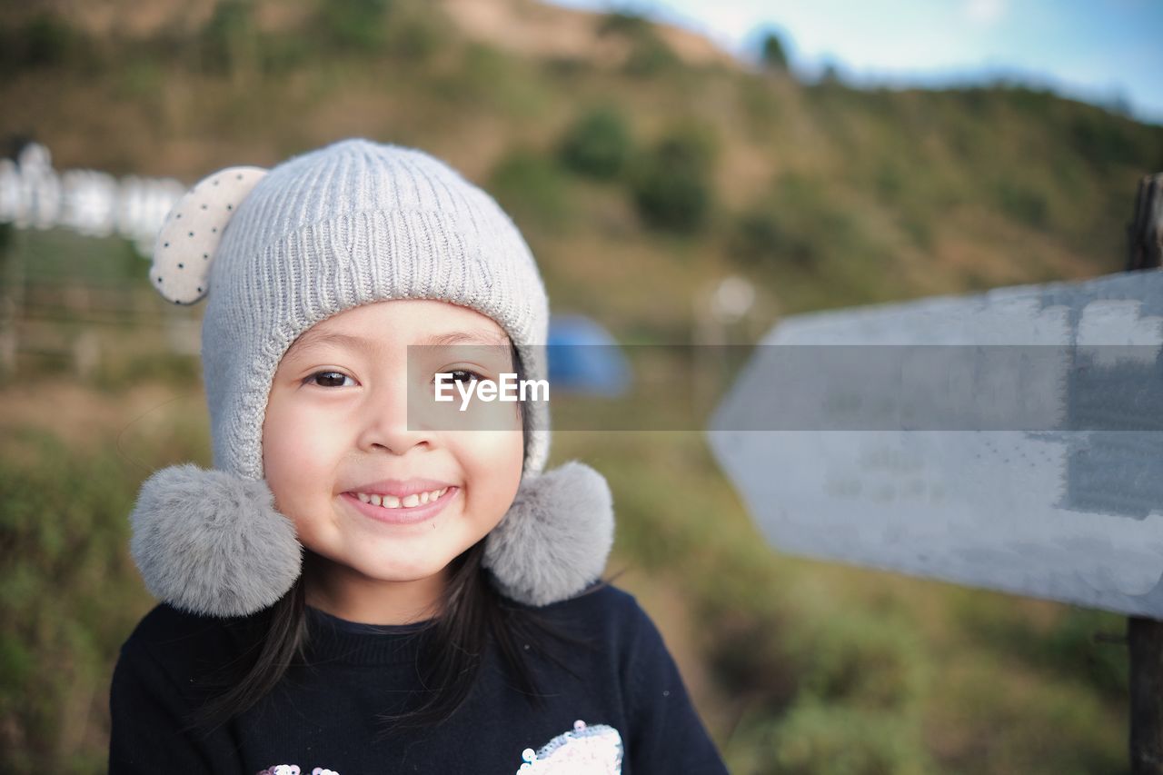 Portrait of a smiling child at top of the mountain in new normal life