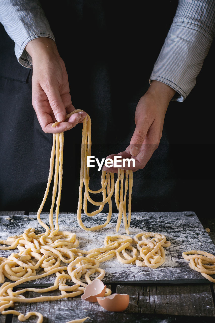 Midsection of man preparing food