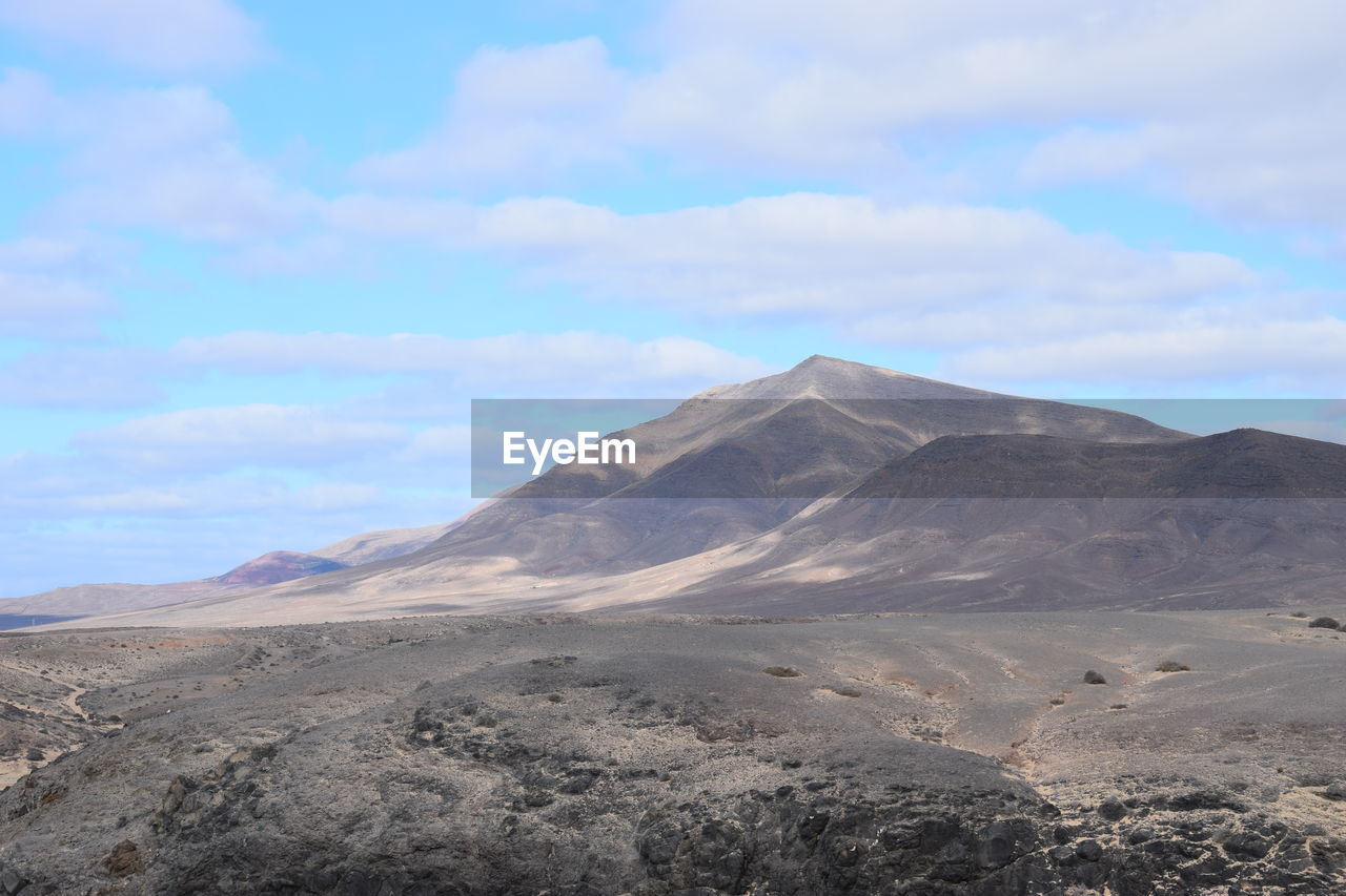View of volcanic land against sky