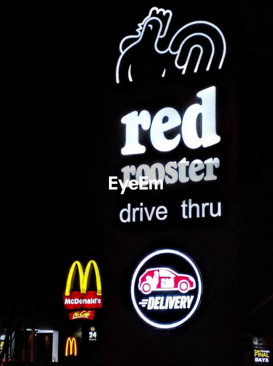 LOW ANGLE VIEW OF ILLUMINATED TEXT ON BLACK SIGN