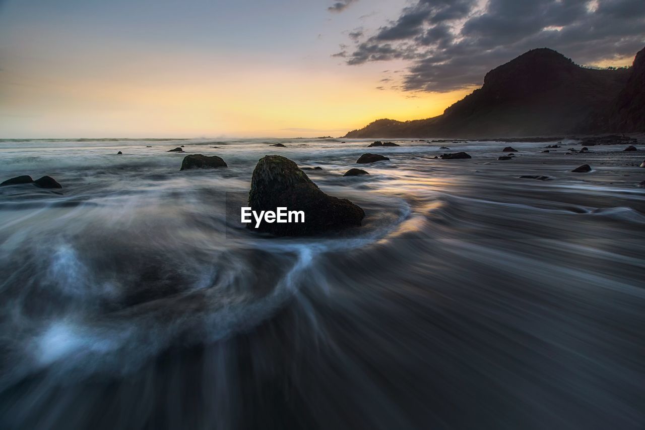 Scenic view of sea against sky during sunset