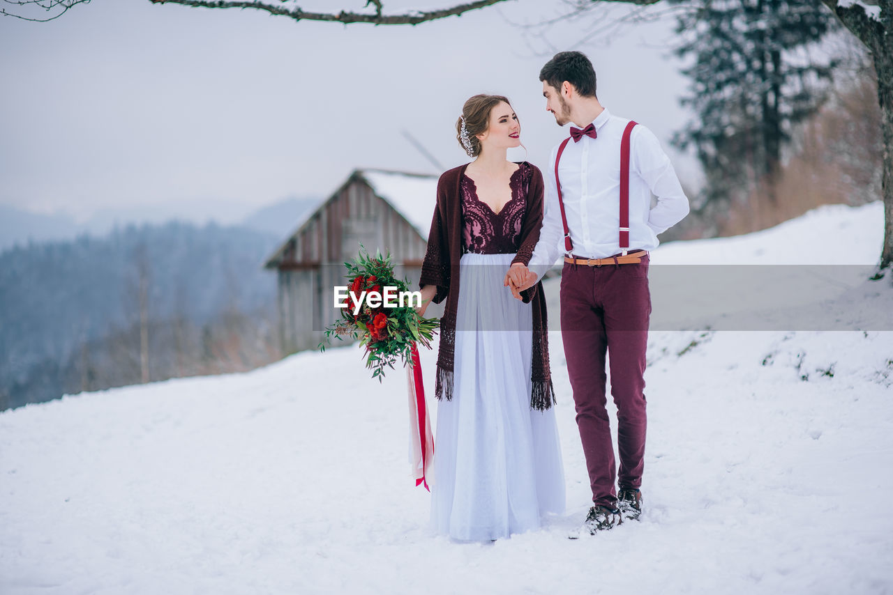 WOMAN ON SNOW COVERED LAND