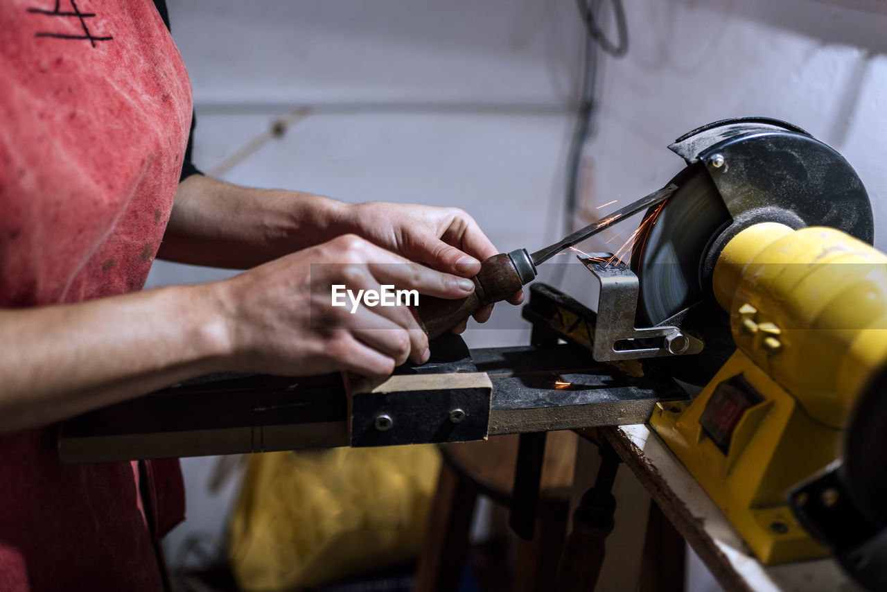 Unrecognized luthier woman in traditional workshop