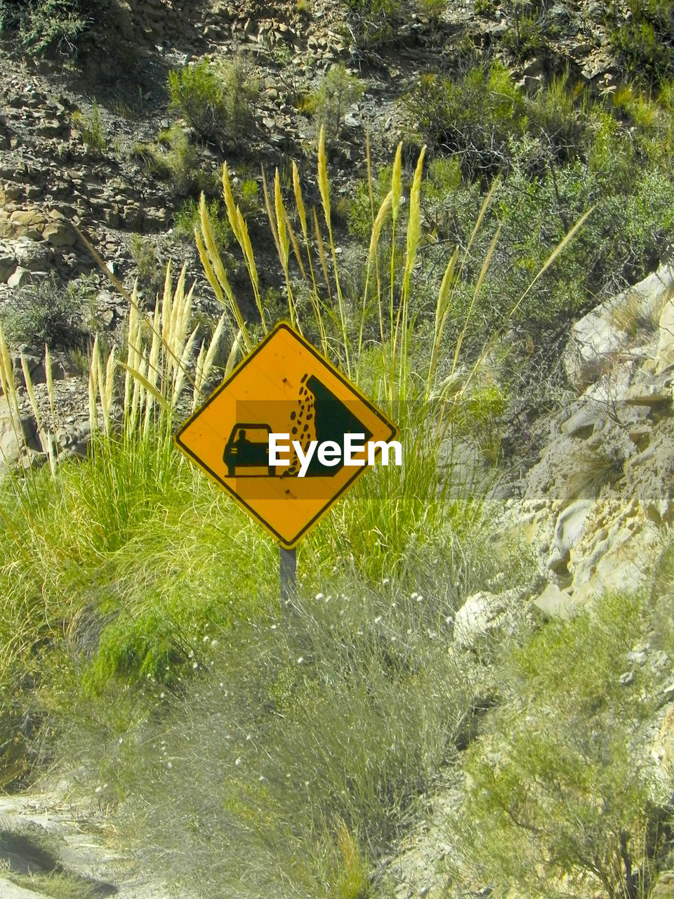 CLOSE-UP OF YELLOW SIGNBOARD IN WATER
