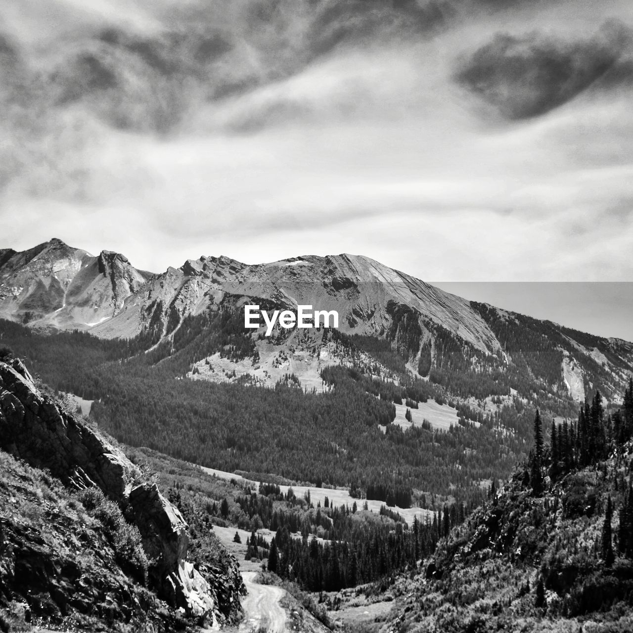 SCENIC VIEW OF SNOWCAPPED MOUNTAINS AGAINST CLOUDY SKY