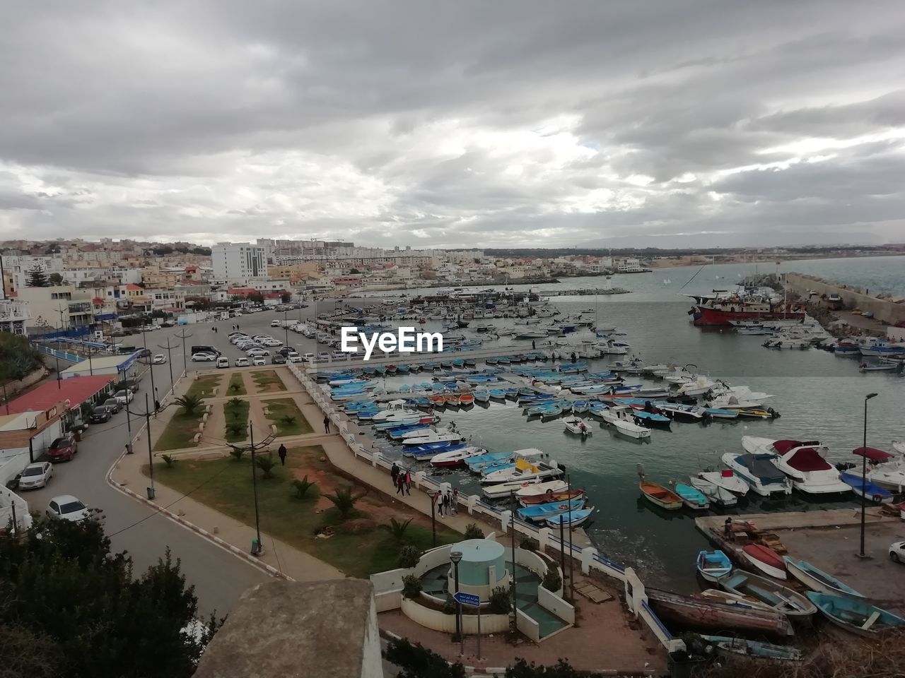 High angle view of marina and buildings against sky