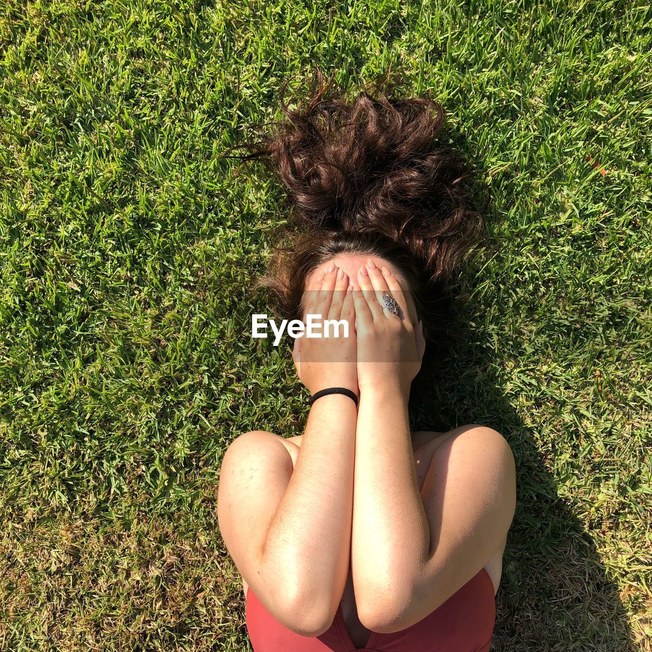 High angle view of woman lying on field