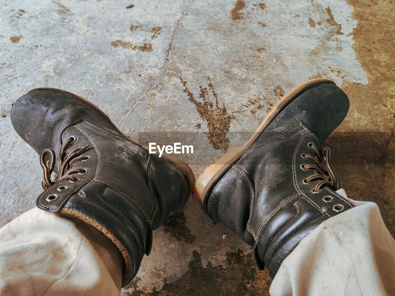 LOW SECTION OF PERSON WEARING SHOES STANDING ON GROUND