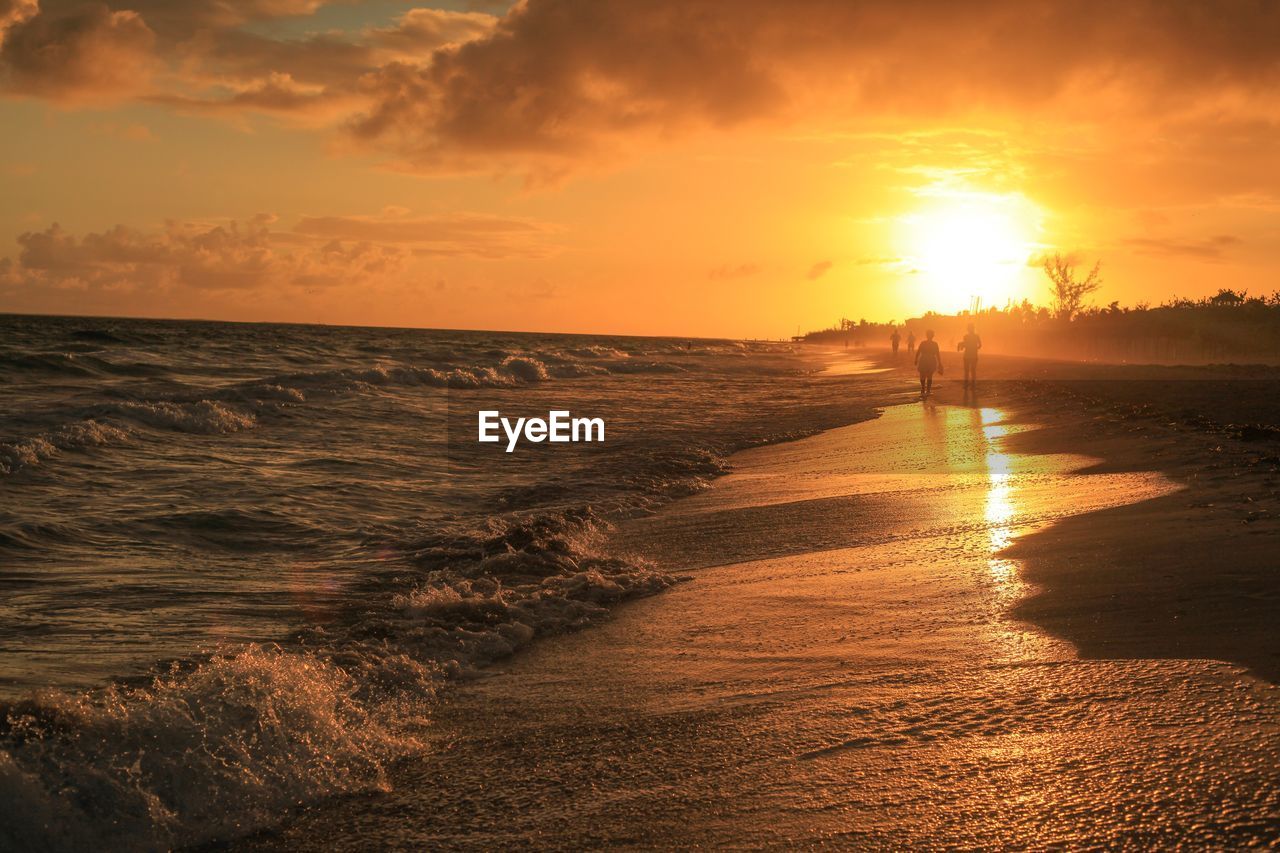SCENIC VIEW OF SEA AGAINST ORANGE SKY