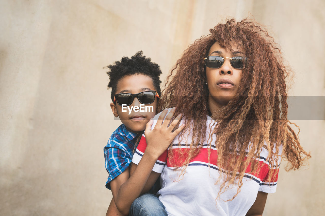 Portrait of mother and son wearing sunglasses outdoors