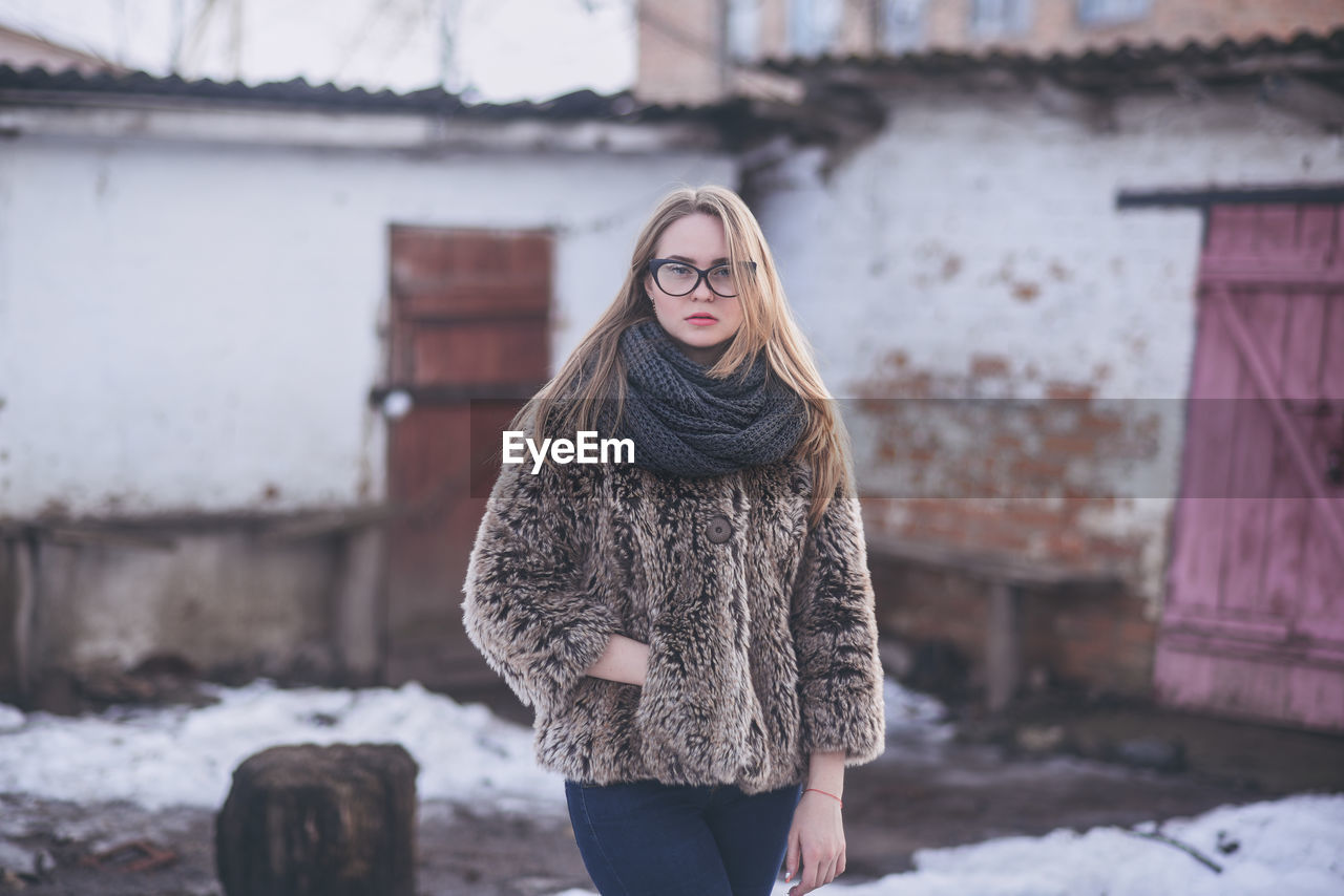 Portrait of woman standing in snow