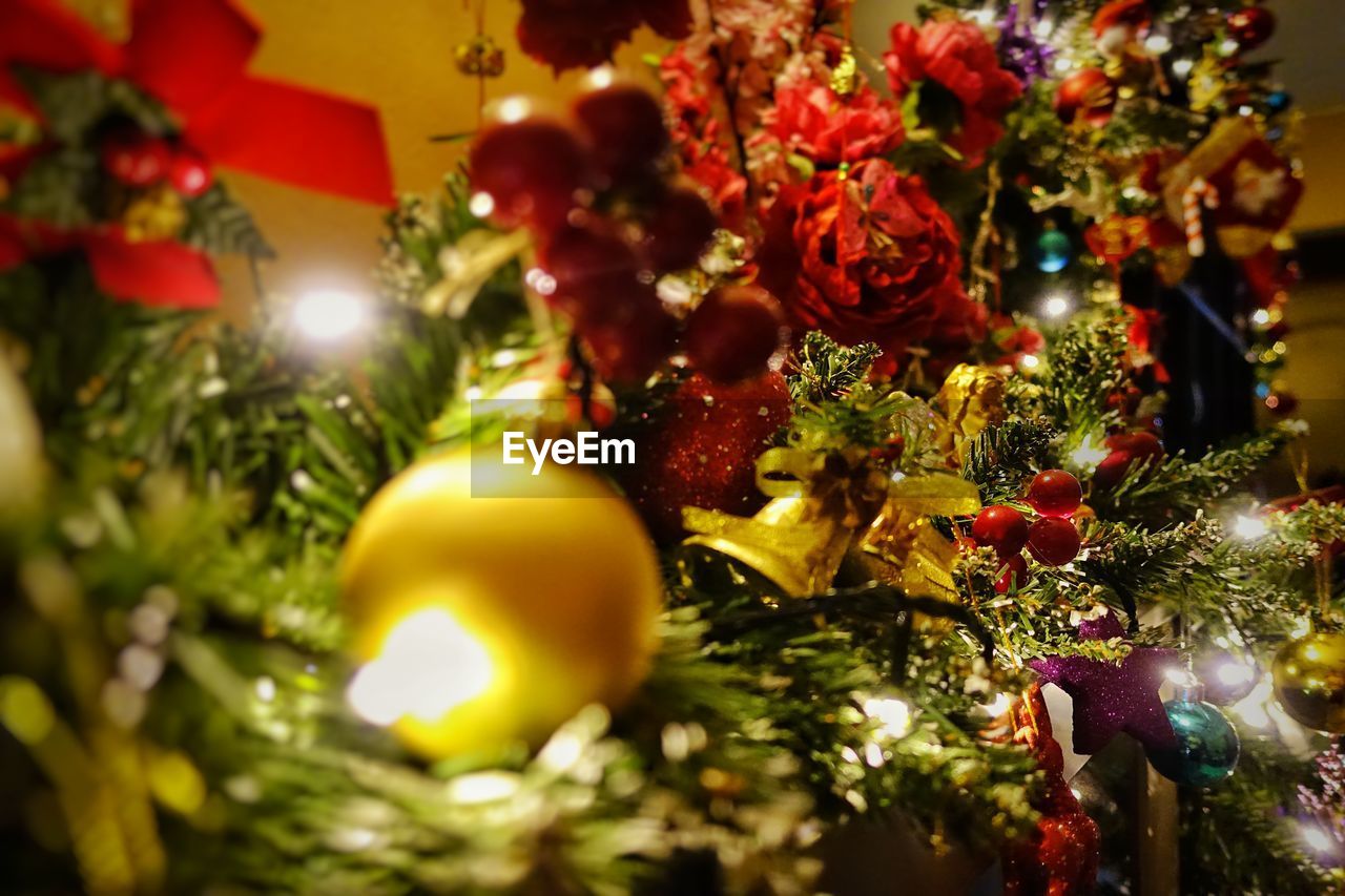 CLOSE-UP OF CHRISTMAS TREE HANGING ON TABLE IN ILLUMINATED TREES