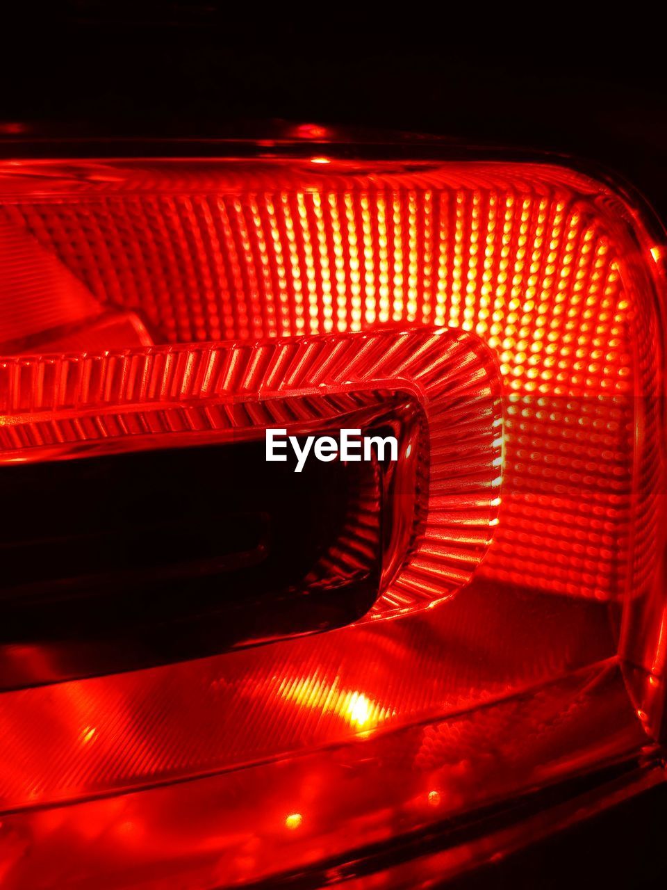 Close-up of illuminated lighting equipment against black background