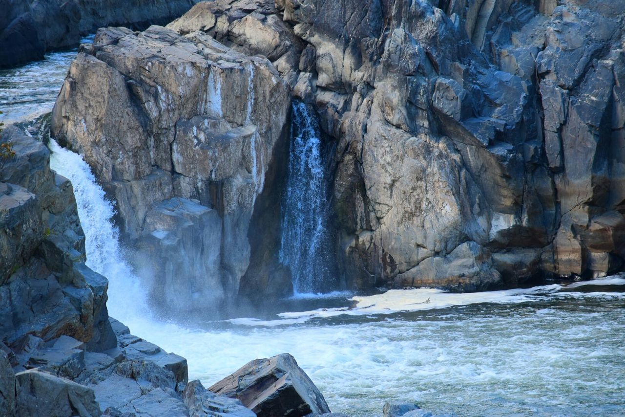 Waterfall over rocky mountain