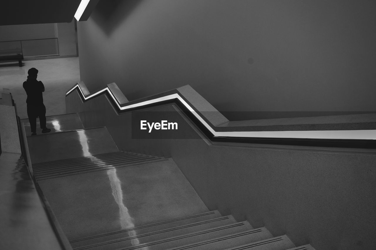 Low angle view of person walking down stairs