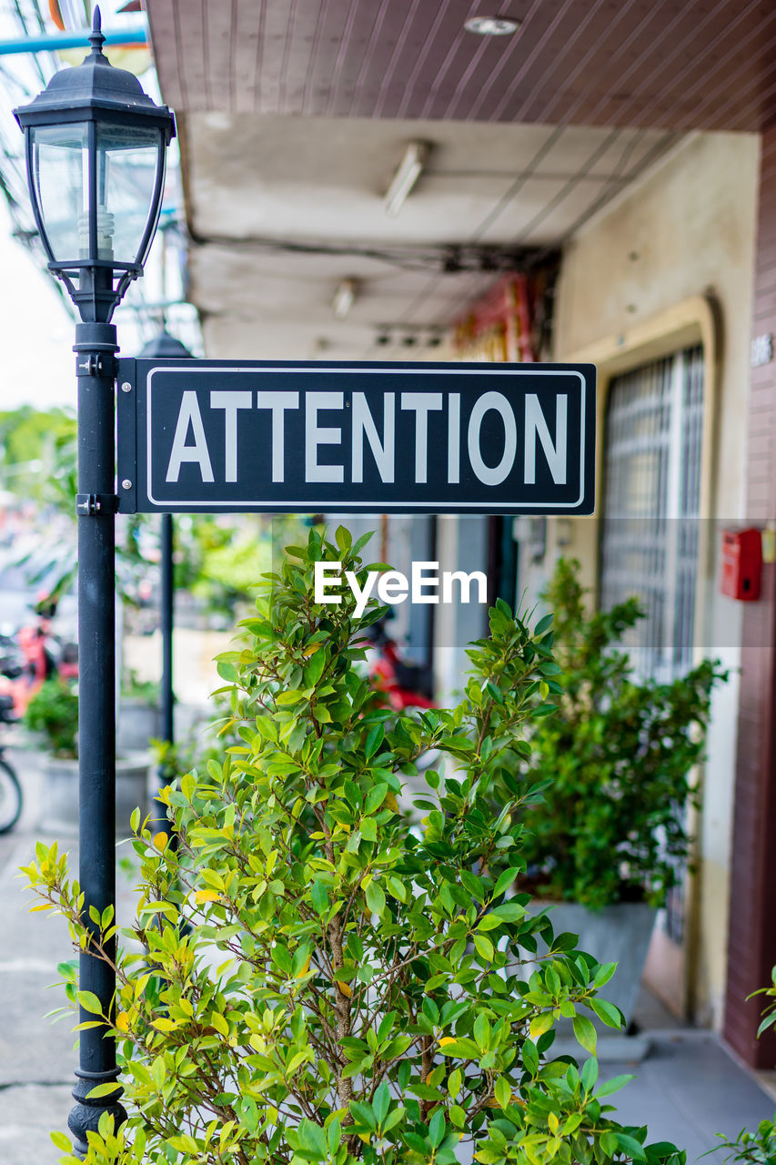 Close-up of signboard on lamp post