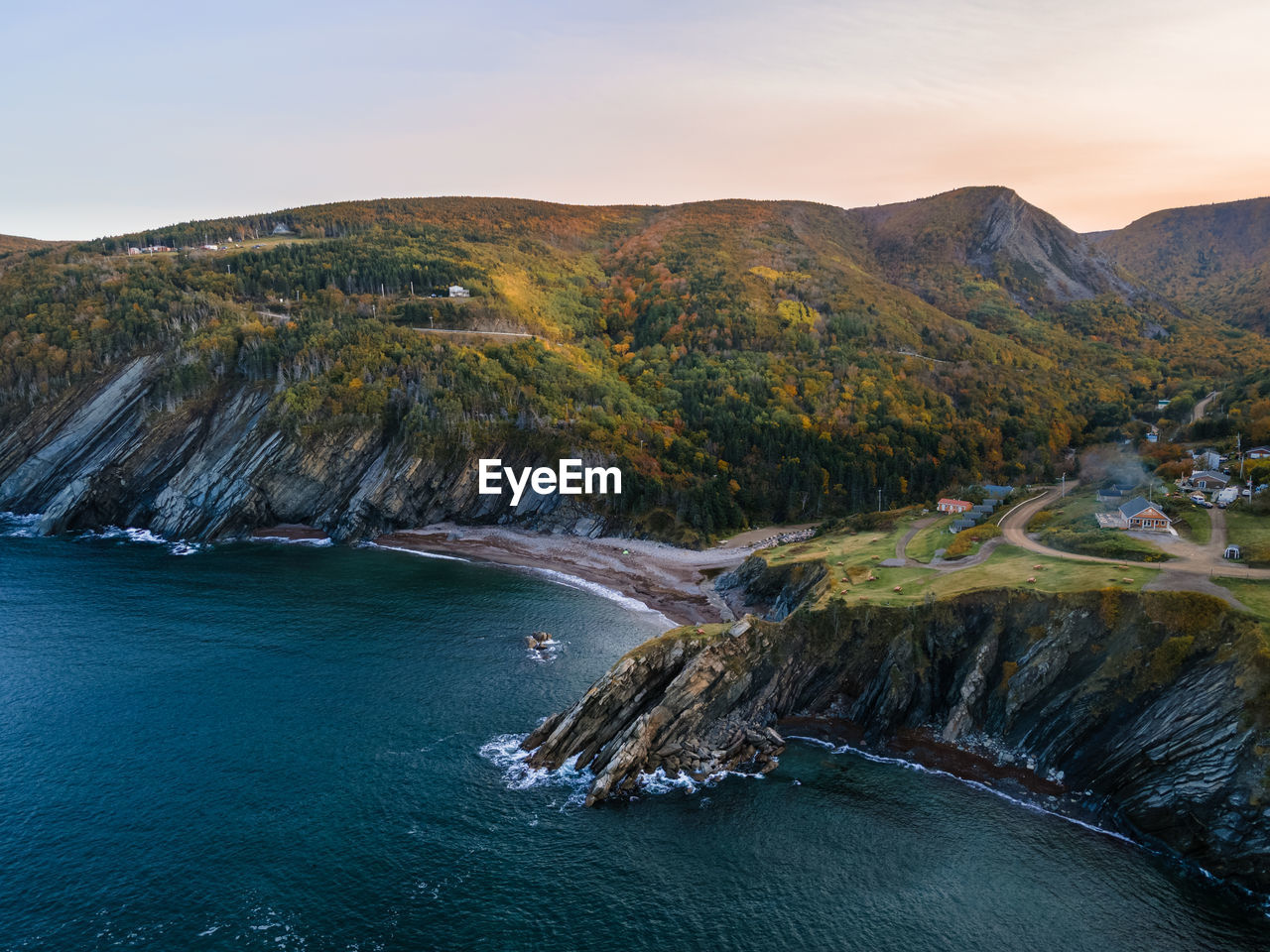 Scenic view of sea and mountains against sky