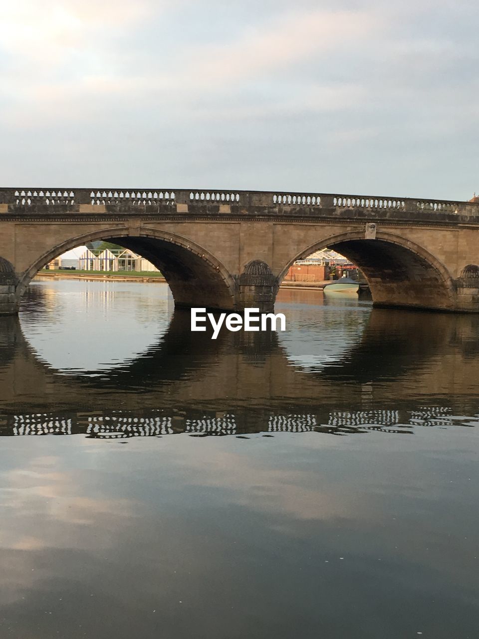 Arch bridge over river against sky