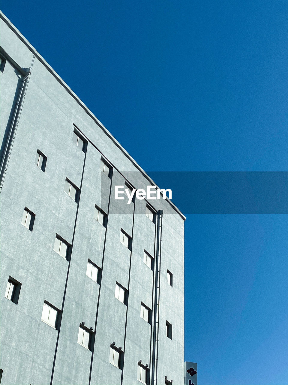 Low angle view of building against clear blue sky