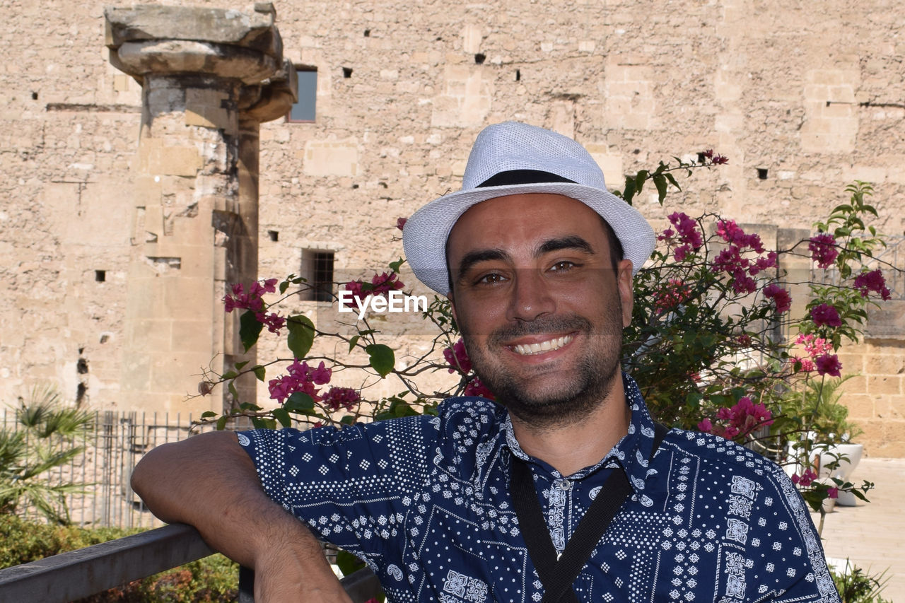 Portrait of smiling man against plants