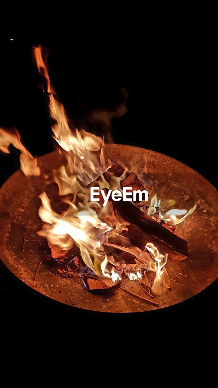 High angle view of illuminated fire pit at night