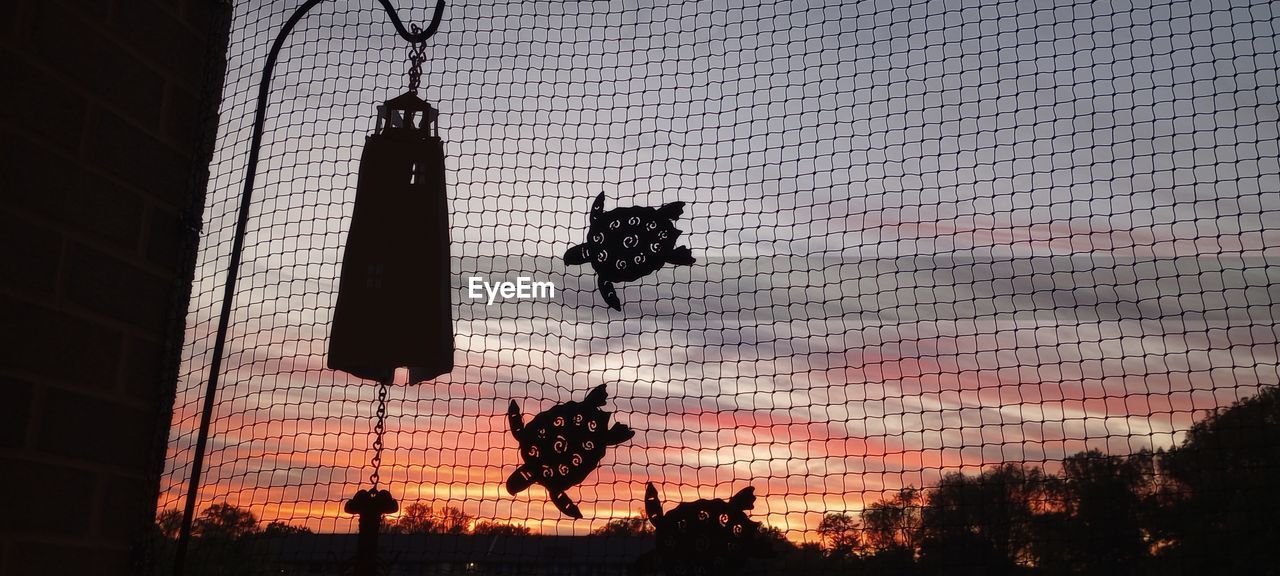 sky, silhouette, sunset, low angle view, nature, architecture, built structure, no people, outdoors, dusk, cloud, building exterior, tree, evening, fence