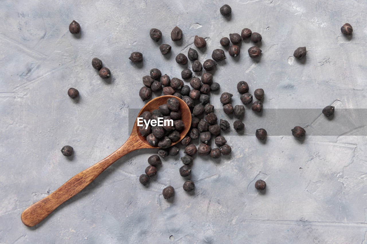 Dry black chickpea from apulia and basilicata on wooden spoon 