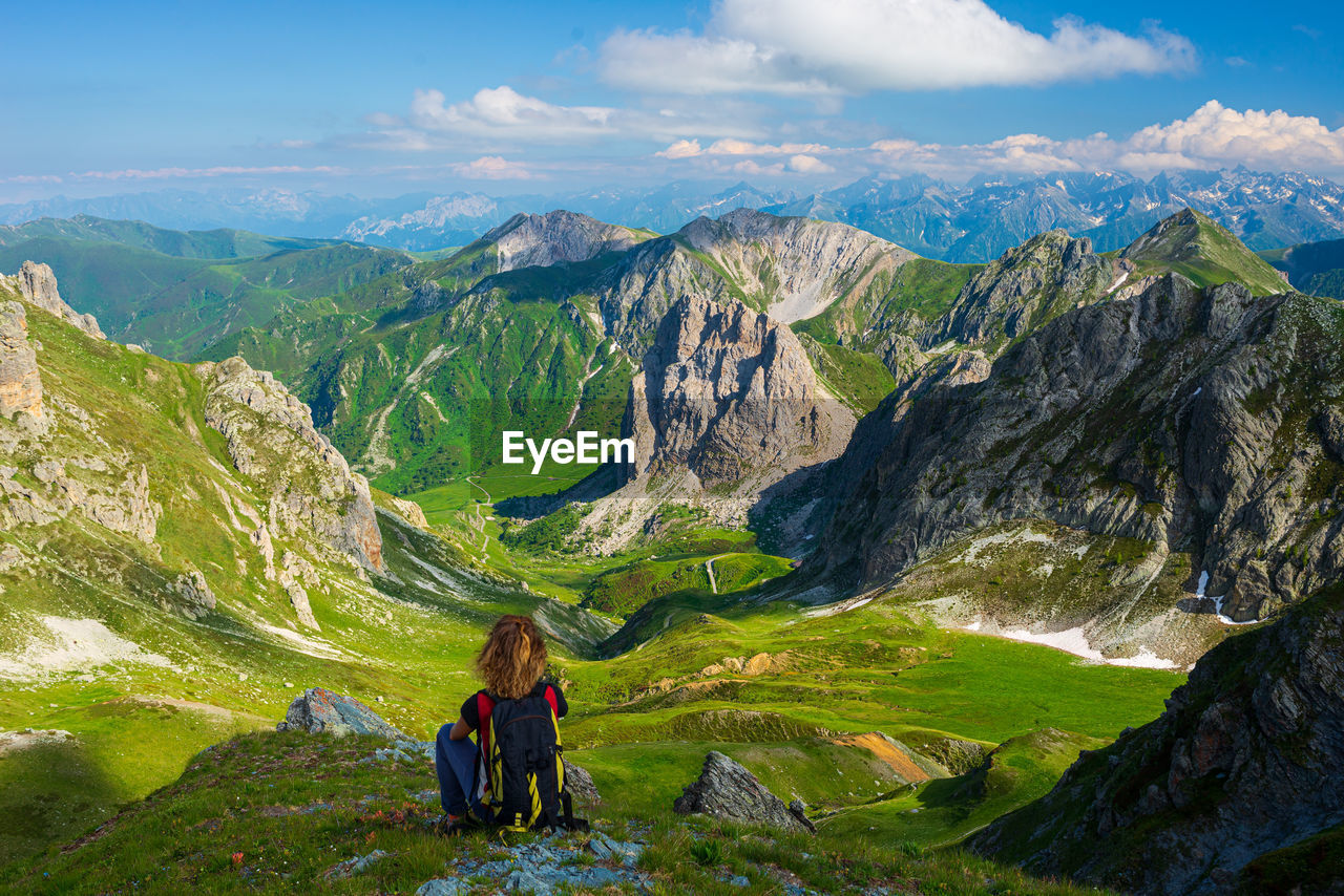 WOMAN LOOKING AT MOUNTAINS