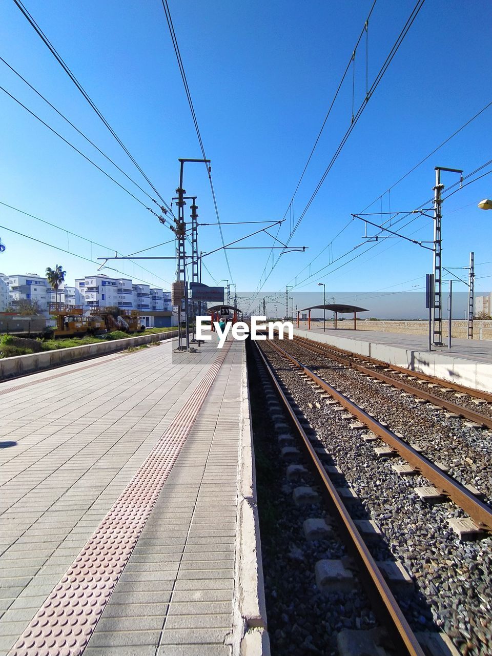 Railroad station platform against clear sky