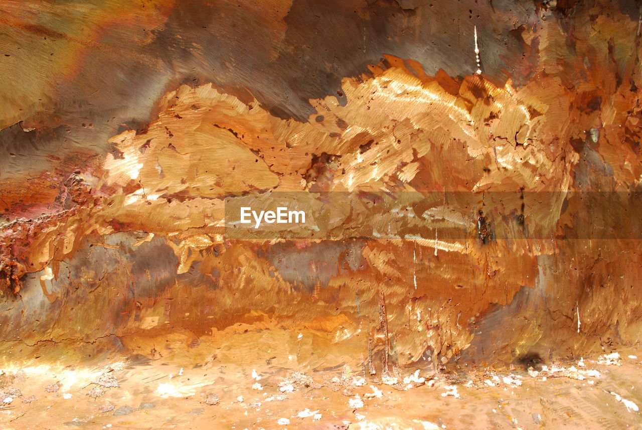 CLOSE-UP OF ILLUMINATED ROCK FORMATION IN CAVE