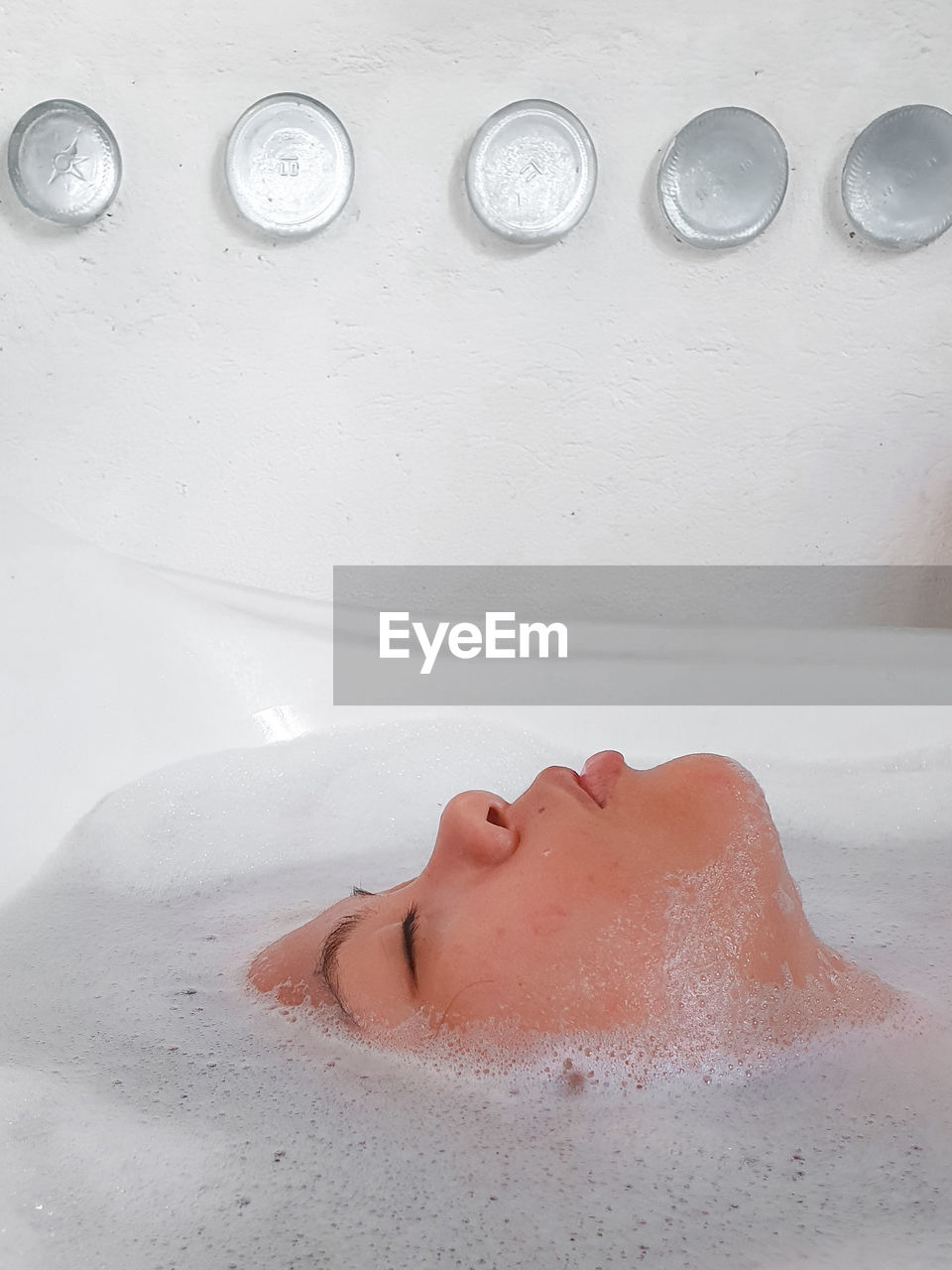 Profile of a woman lying down in bathtub