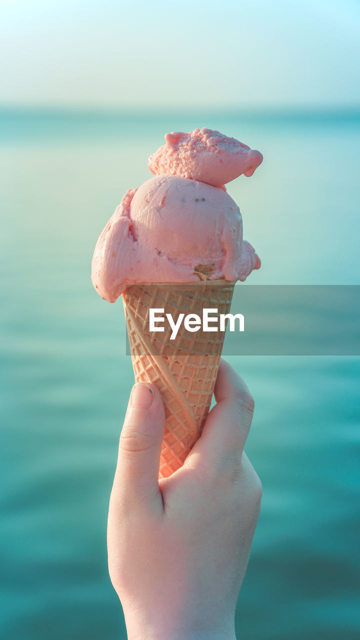 Close-up of hand holding ice cream cone