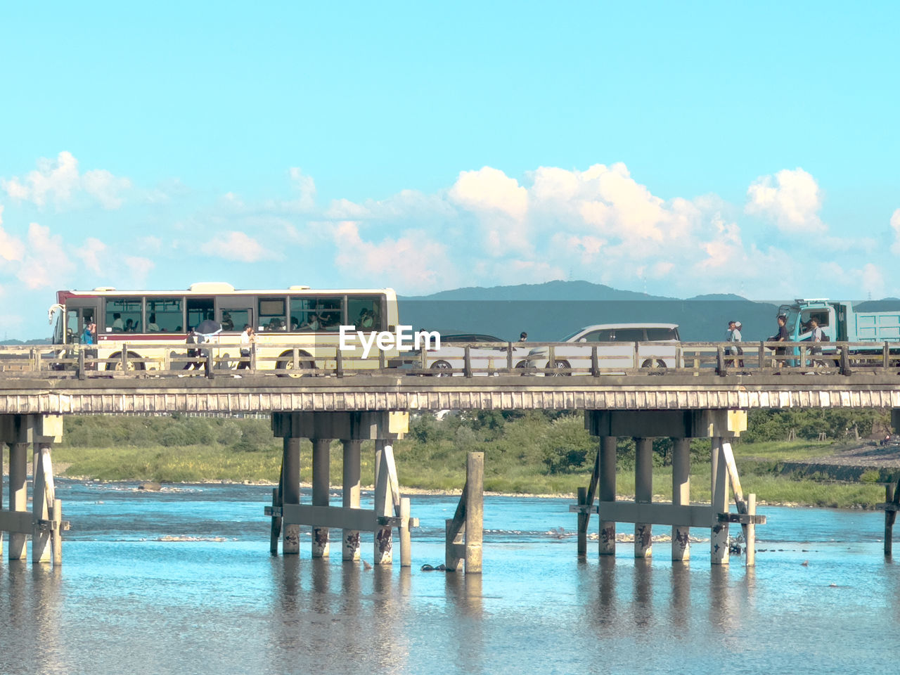 water, sky, architecture, pier, built structure, nature, sea, vacation, cloud, day, transportation, bridge, travel, travel destinations, reflection, blue, building exterior, beach, outdoors, coast, tourism, land, no people, dock, waterfront, shore, city