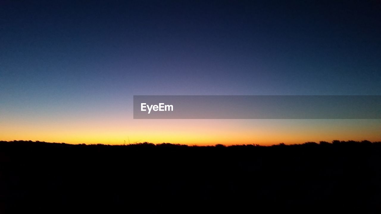 SILHOUETTE LANDSCAPE AGAINST CLEAR SKY