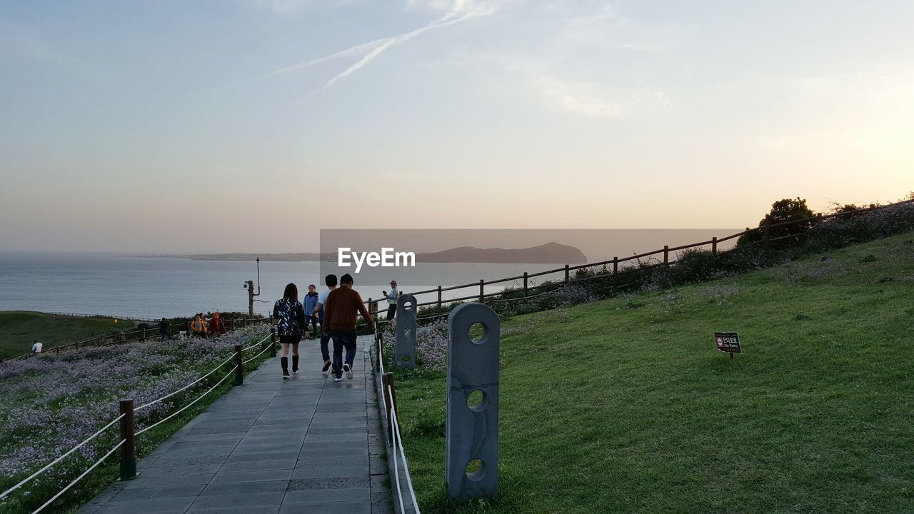 PEOPLE ON SEA AGAINST SKY